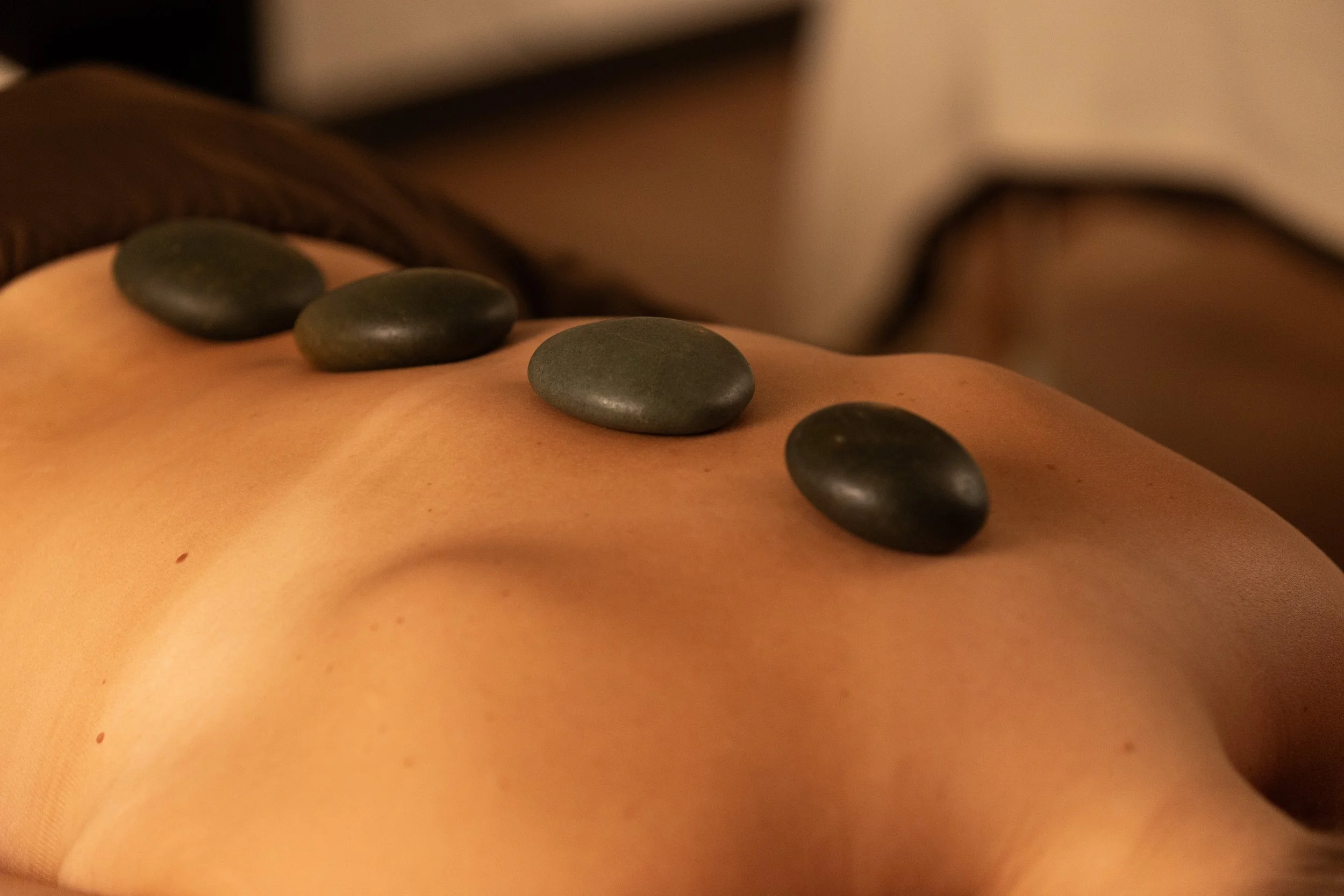 Hot stones on a client's back